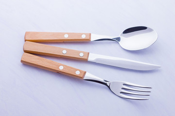 Set of cutlery: knife, fork, spoon on white background. Table setting. Concept of cutlery with...