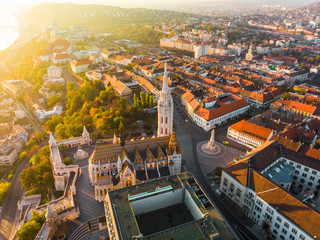 Aerial view of Fishermans Bastion and Matthias Church from above in Budapest during sunrise in autumn with dramatic sky (Budapest, Hungary, Europe)