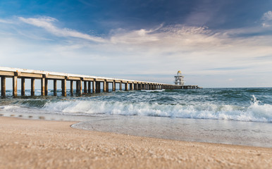 Cement walking bridge in the beach to the sea.