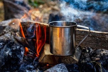 steel cup on an open fire in nature.