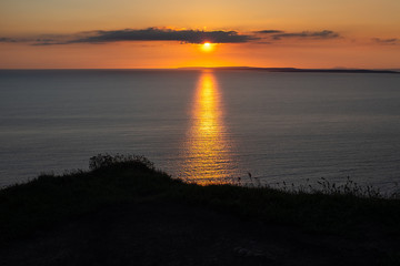 Stunning golden sunset from the Cliffs of Moher looking out towards the island of Inisheer, Ireland