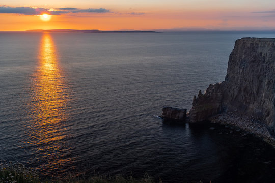 Stunning golden sunset from the Cliffs of Moher looking out towards the island of Inisheer, Ireland