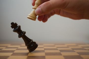 White bishop hitting a black king, chess game end with a checkmate