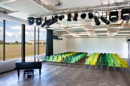 Chairs and grand piano in empty room