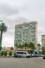 Fototapeta na wymiar Cars parked in front of a big office building on the Independance square (Plaza Indepencia), Montevideo, Uruguay, January 25th 2019
