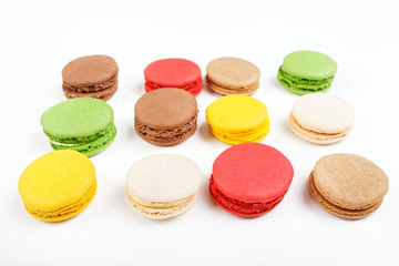 Macarons on a white background. Multicolored sweet macarons laid out in rows.