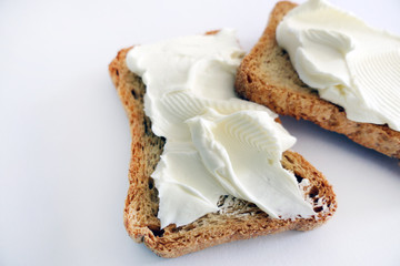 Two Bread Toasts with Cream Cheese isolated on a White Background