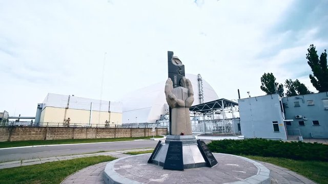 Panoramic fisheye view of the Chernobyl atomic station cortyard with memorial statue. Walking around disastrous power plant with amazing history. Chernobyl Zone, Ukraine