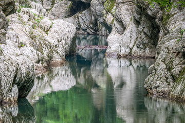 Fototapeta na wymiar Mountain river in the stone gorge.