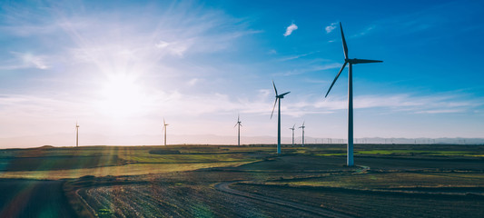 Birds eye view of turbines propellers rotating from wind power producing clean eco energy and saving natural resources from climate change. Alternative electricity generation with friendly technology