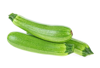 Three freshly zucchini on a white background