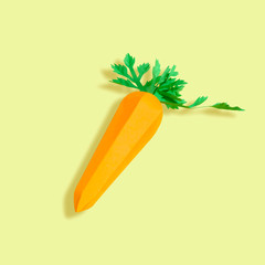 Paper carrot on yellow background