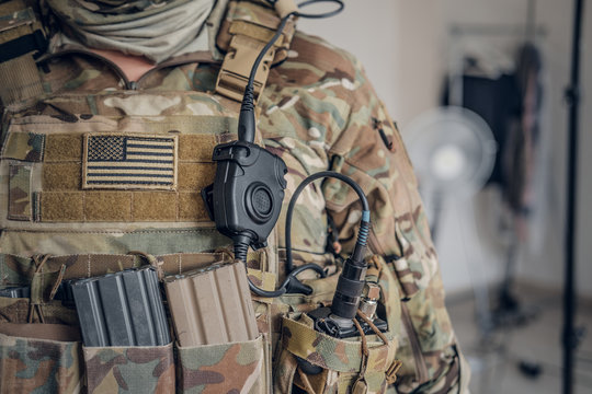 Closeup photo shoot of military man in USA army uniform with radio in his pocket.