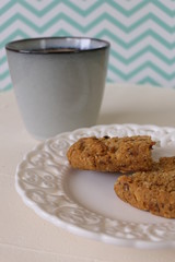 Cookies in a Plate with Caffee on a White and Green Zigzag Background