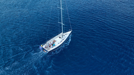 Fototapeta premium Aerial photo of beautiful wooden deck sail boat cruising the Aegean blue sea, Greece