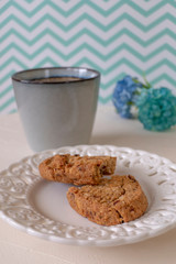 Cookies in a Plate with Caffee on a White and Green Zigzag Background