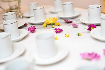 cup of coffee and cake on table, natural flowers