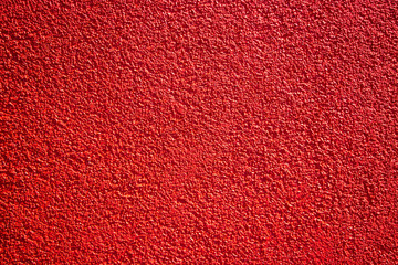 Red painted wall concrete stucco surface texture