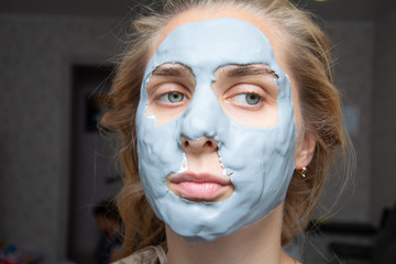 Spa Woman applying Facial clay Mask. Beauty Treatments.facial cleansing, cosmetology, beauty mask