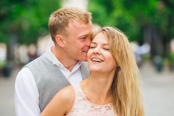 The guy hugs and kisses the girl in the park. smile.