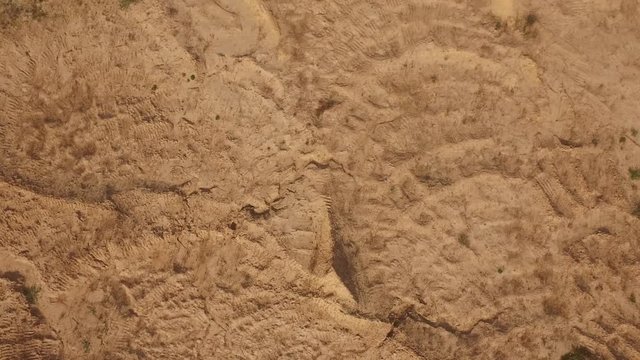 Aerial view of red sand in a desert or wilderness in summer day. Sene. View from above of sand textures