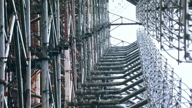 Abstract view of gigantic radio center on high voltage in the courtyard of a nuclear power plant. View of telecommunication antenna tower non-working for years. Chernobyl, Ukraine