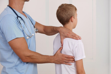 Child having chiropractic back adjustment. Osteopathy, Physiotherapy, Kinesiology. Bad posture...
