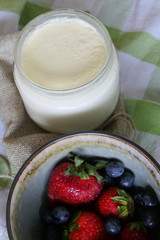 Homemade Yoghurt with Fresh Strawberries and Blueberries on a Wooden Background