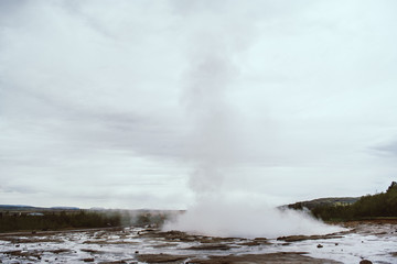 Stages of the eruption of the famous Strokkur Geyser In Iceland on a cold cloudy afternoon. Giant blue bubble right before the eruption