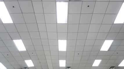 rows of lighting on white ceiling