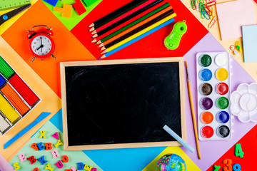 Teaching children of primary school. Bright and multicolored school background with stationery accessories for the study of general subjects. Flat Lay, Copy space, Mock up, top view, place for text.