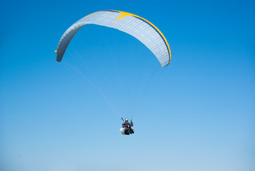Skydivers competition. Parachutes against the blue sky.