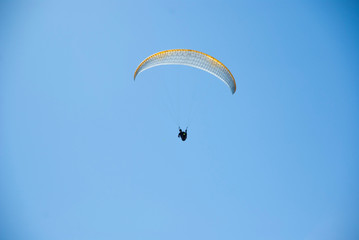 Skydivers competition. Parachutes against the blue sky.