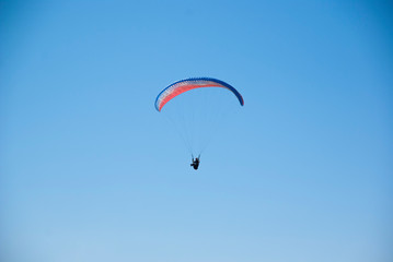 Fototapeta na wymiar Skydivers competition. Parachutes against the blue sky.