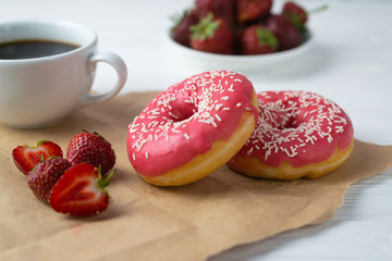 Homemade fresh baked donuts with strawberry pink frosting