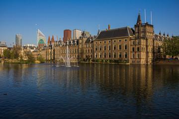 Fototapeta na wymiar the Hague (den Haag), the Netherlands, Holland,, April 20, 2019. Binnenhof palace (Dutch Parliament), Mauritstoren (tower of Maurits) pond with fountain view side