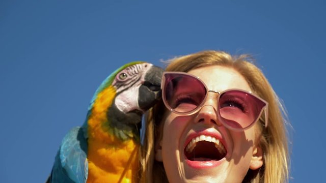 Blonde Model Laughs as Parrot Removes Her Pink Sunglasses