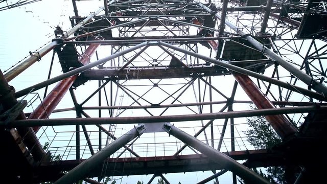 Abstract view of the massive radiolocation antenna complex "Duga" in old town Chernobyl-2. Standing under large military object in Chernobyl Zone, Ukraine.