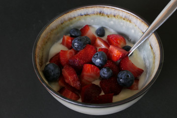 Homemade Yoghurt with Fresh Strawberries and Blueberries on a Wooden Background
