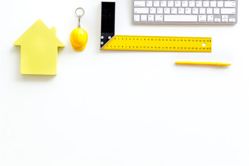ruler, keyboard, house figure, tools for architect work on white desk background top view copyspace