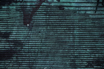 Teal worn grunge corrugated metal shutter background texture