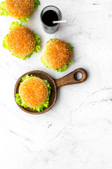 Burger and drink for national american kitchen concept on marble background top view mock up