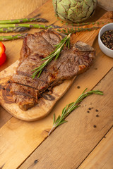 Steak with vegetables on a wooden background, restaurant and hotel business, menu, homemade recipes, culinary background, vertical photo, banner