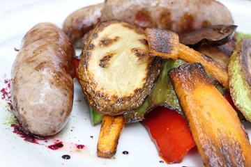 Grilled Sausage with Roasted Vegetables in a White Plate