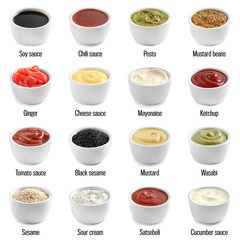 Set of different delicious sauces on white background