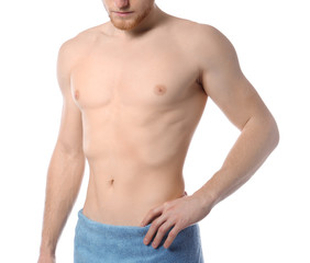 Young man with slim body in towel on white background, closeup