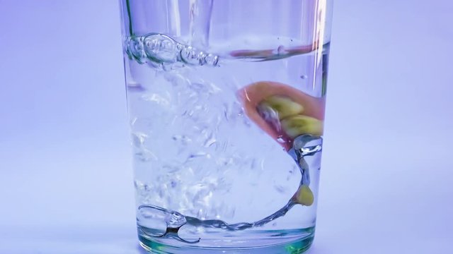 Closeup scene of cleaning denture by using fizzy tablet in a glass of fresh water