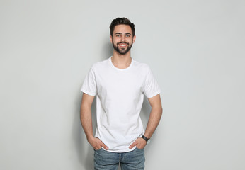 Young man in t-shirt on light background. Mock up for design - obrazy, fototapety, plakaty