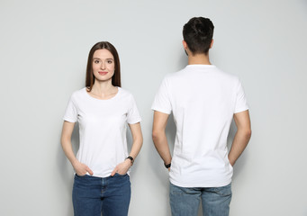 Young people in t-shirts on light background. Mock up for design