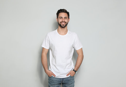 Young man in t-shirt on light background. Mock up for design